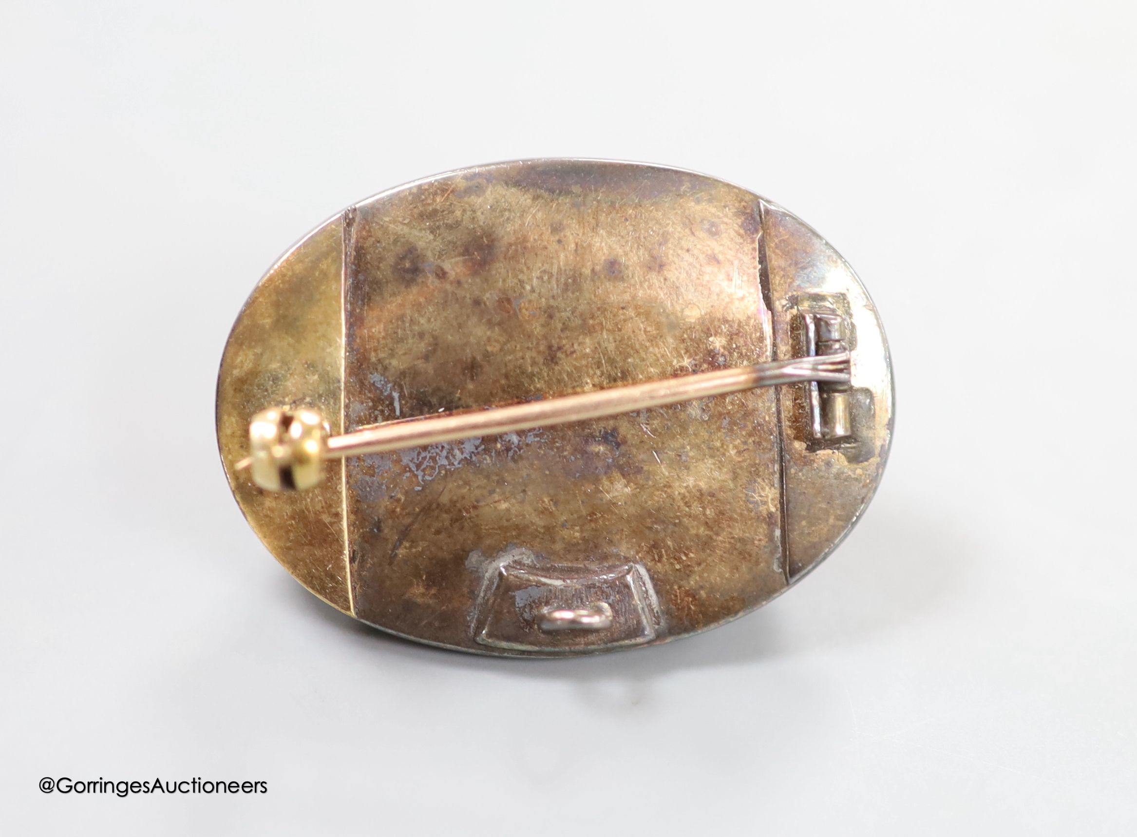 A 19th century yellow and white metal, oval cabochon garnet, rose and old cut diamond set brooch(adapted and stone cracked), with central star motif, 34mm, gross weight 15.9 grams.
